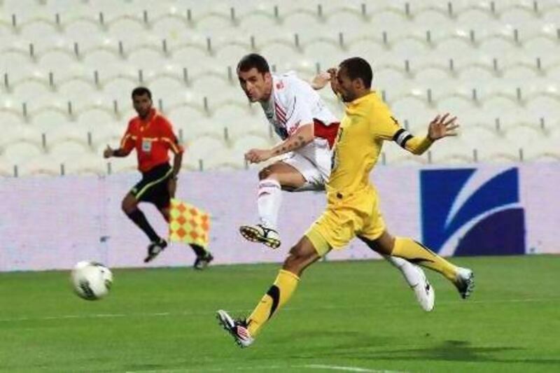 Al Jazira, in white, beat Al Wasl despite some key players missing from the pitch in Abu Dhabi last night. Ravindranath K / The National