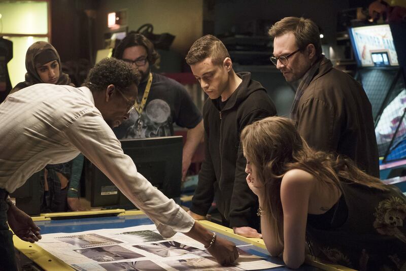 In the foreground from left, Ron Cephas Jones as Romero, Rami Malek as Elliot, Christian Slater as Mr Robot and Carly Chaikin as Darlene in Mr Robot. USA Network / NBCU Photo Bank via Getty Images
