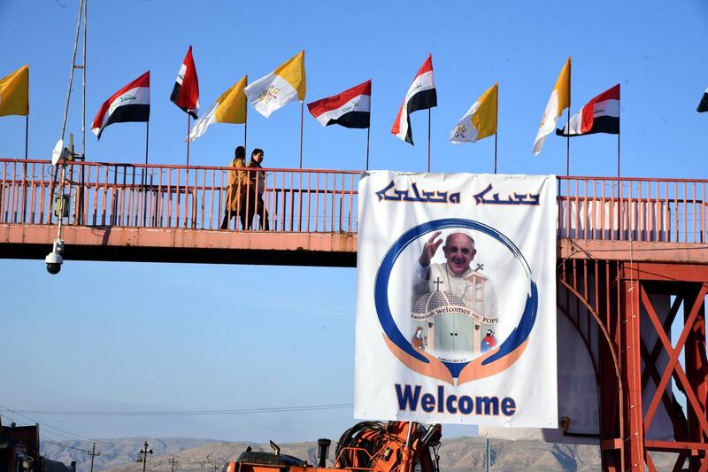 Iraqi and Vatican flags and a picture of Pope Francis in Qaraqosh, about 30 kilometres east of Mosul in northern Iraq. EPA