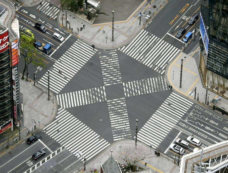 An aerial view shows less than usual passersby seen at a pedestrian crossing at Ginza shopping and amusement district  in Tokyo, Japan. Reuters