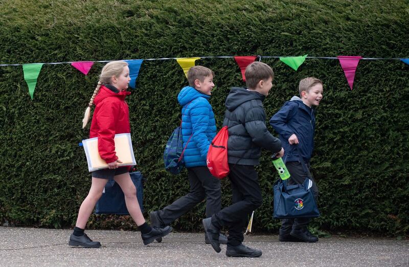 Children arrive at a Primary Academy in Shipdham, England, Monday March 8, 2021. British children are returning to school on Monday after a two-month closure, part of what Prime Minister Boris Johnson said was a plan to get the country to â€œstart moving closer to a sense of normality.â€ (Joe Giddens/PA via AP)