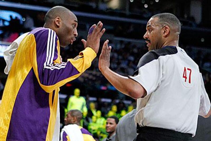 Bryant argues with referee Adams after storming off to the bench for getting a technical foul during the NBA game against the San Antonio Spurs in California.