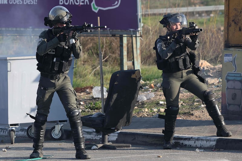 Israeli soldiers aim at Palestinians protesting over the expropriation of their land near the Jewish settlement of Beit El. AFP