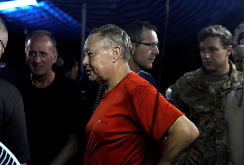 British divers Robert Charles Harper and John Volanthen chat with Thailand military officer, not pictured, near the Tham Luang cave complex, as members of under-16 soccer team and their coach have been found alive according to a local media's report, in the northern province of Chiang Rai, Thailand, on July 2, 2018. Soe Zeya Tun / Reuters
