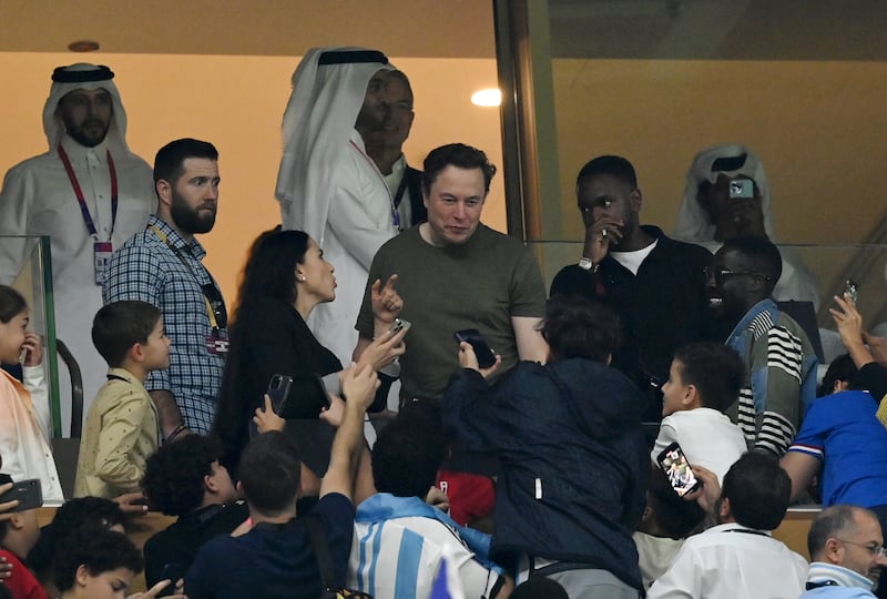 Fans take photos with Twitter boss Elon Musk during the World Cup final at the Lusail Stadium on Sunday. Getty