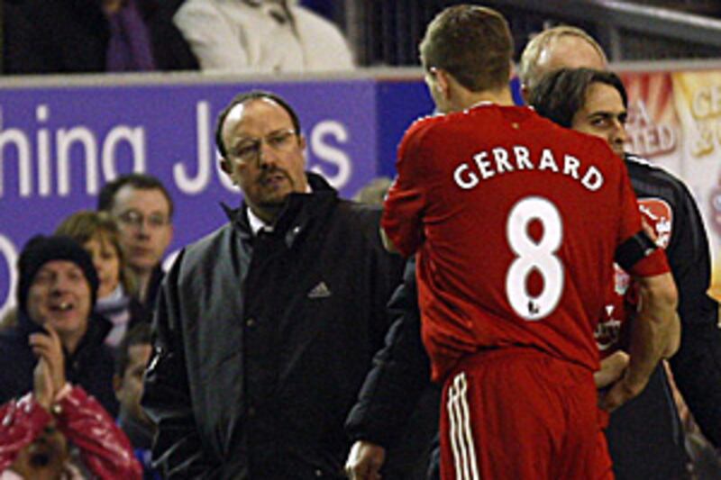 Rafa Benitez, left, looks on as his captain Steven Gerrard, centre, is substituted after 16 minutes in Liverpool's extra-time defeat to Everton in the FA Cup fourth round replay.