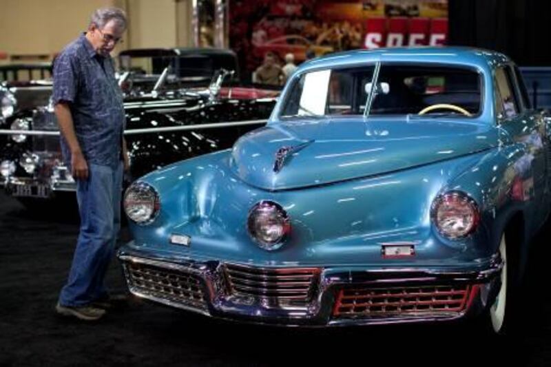 A car enthusiast looks at a 1948 Tucker Torpedo on display at the Barrett-Jackson Collector Car Auction, Thursday, Sept. 22, 2011, in Las Vegas. The auction, celebrating its 40th anniversary and in its fourth year in Las Vegas, runs through Saturday. (AP Photo/Julie Jacobson)