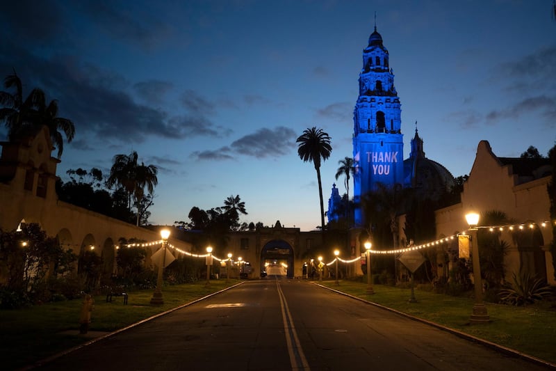 A 'thank you' message and blue floodlights in honor of health care workers and first responders are visible on the California Tower and Museum of Man in an empty Balboa Park, in San Diego. AP Photo
