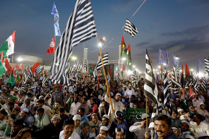 Supporters of Pakistan Democratic Movement (PDM), an alliance of political opposition parties, wave flags as they listen to their leaders during an anti-government protest rally in Karachi, Pakistan October 18, 2020. REUTERS/Akhtar Soomro