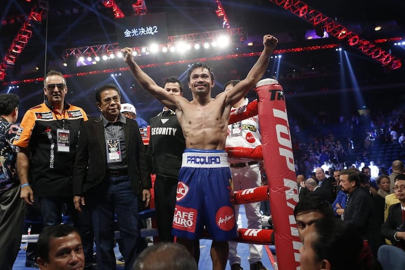 Manny Pacquiao, celebrating after his win over Chris Algieri on November 23, is not paying any special attention to Floyd Mayweather. Kin Cheung / AP Photo