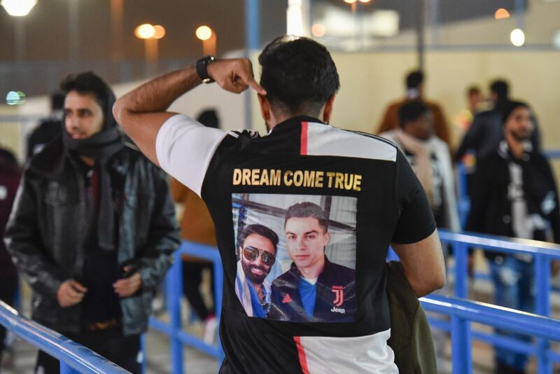 A Juventus supporter displays his picture with Juventus' forward Cristiano Ronaldo at the King Saud University Stadium. AFP