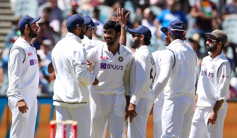 India's Jasprit Bumrah, centre, is congratulated by teammate after dismissing Australia's Pat Cummins. AP