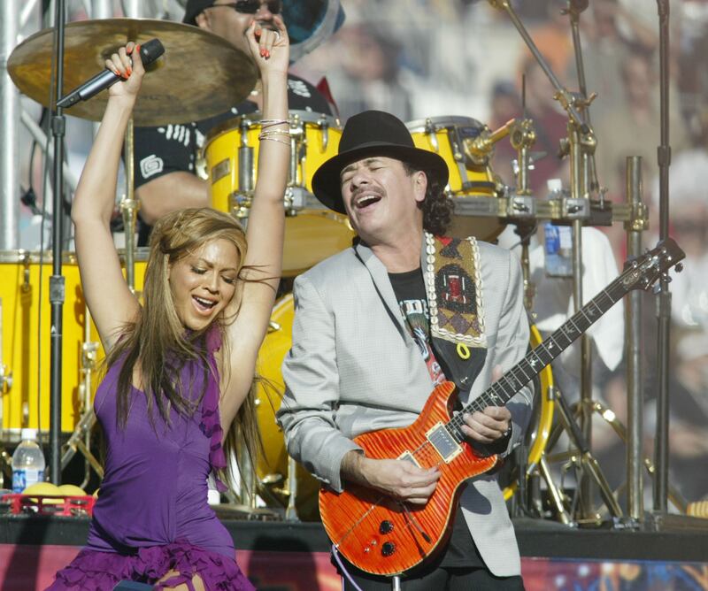 Guitarist Carlos Santana and singer Beyonce perform at the Super Bowl pre-game show at San Diego's Qualcomm Stadium, January 26, 2003. Reuters