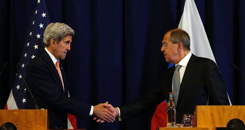 US secretary of state John Kerry and Russian foreign minister Sergei Lavrov shake hands in Geneva where they discussed the crisis. Kevin Lamarque / AFP