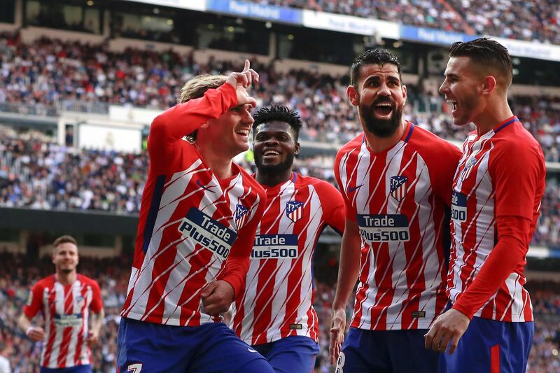 MADRID, SPAIN - APRIL 08: Antoine Griezmann (L) of Atletico de Madrid celebrates scoring their opening goal with teammates Thomas Teye Partey (2ndL), Diego Costa (2ndR) and Lucas Hernandez (R) during the La Liga match between Real Madrid CF and Club Atletico de Madrid at Estadio Santiago Bernabeu on April 8, 2018 in Madrid, Spain. (Photo by Gonzalo Arroyo Moreno/Getty Images)