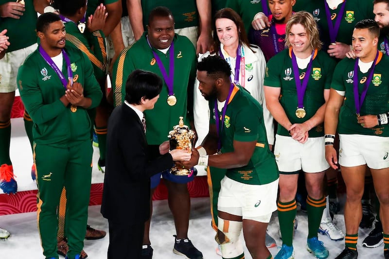 Japan's Crown Prince Akishino (front L) presents the Webb Ellis Cup to South Africa's flanker Siya Kolisi as they celebrate winning the Japan 2019 Rugby World Cup final match between England and South Africa at the International Stadium Yokohama in Yokohama.  AFP