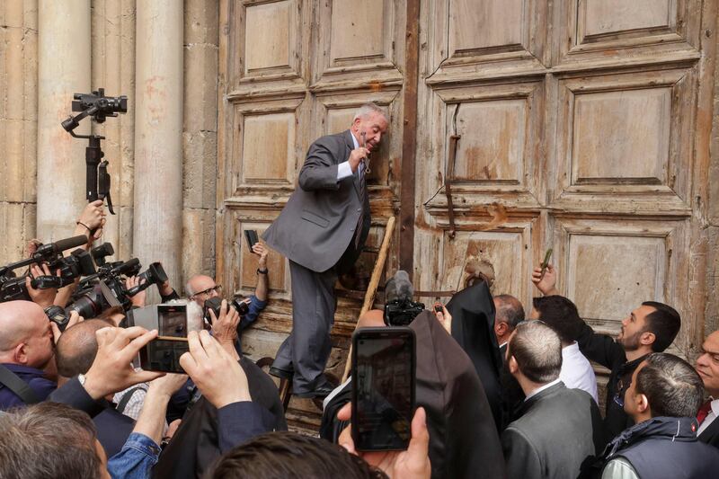 A custodian in charge of the ancient key to the Church of the Holy Sepulchre unlocks the doors ahead of the Holy Fire ceremony in Jerusalem's old city. AFP