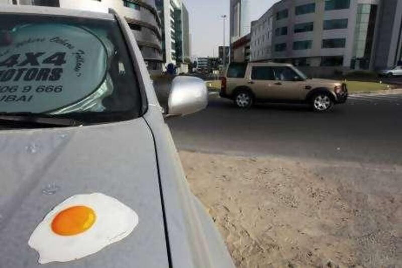 United Arab Emirates - Dubai - Sep 19 - 2010 : A picture of a fried eggs stuck on the bonnet of a car in Media City. It's part of an RTA campaign to  get people into public transport. ( Jaime Puebla / The National ) 