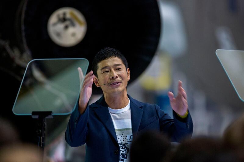 Japanese billionaire Yusaku Maezawa speaks near a Falcon 9 rocket during the announcement by Elon Musk to be the first private passenger who will fly around the Moon aboard the SpaceX BFR launch vehicle, at the SpaceX headquarters and rocket factory on September 17, 2018 in Hawthorne, California. Japanese billionaire businessman, online fashion tycoon and art collector Yusaku Maezawa was revealed as the first tourist who will fly on a SpaceX rocket around the Moon. / AFP / DAVID MCNEW
