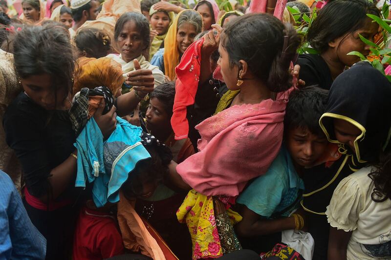 Newly arrived Rohingya refugees struggle for relief materials at Kutupalong refugee camp in Bangladesh's Ukhiya district. Munir Uz Zaman / AFP