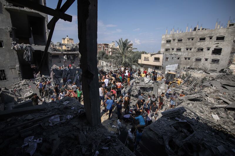 Palestinian residents search the rubble of a destroyed building following an Israeli air strike in Gaza. Bloomberg