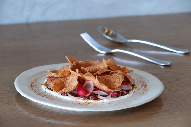 Dubai, United Arab Emirates - April 24, 2019: Postcard: Lowe Dubai restaurant. Smoked organic beef tartare, chipotle, soured onion cream, radish. Wednesday the 24th of April 2019. KOA Canvas, Dubai. Chris Whiteoak / The National