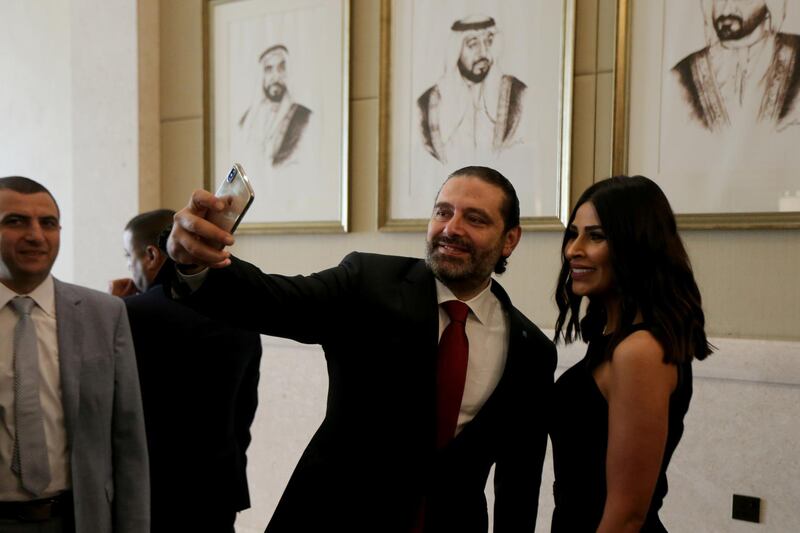 Lebanese Prime Minister Saad Hariri takes a selfie with a participant at the UAE-Lebanon Investment Forum in Abu Dhabi, UAE. REUTERS