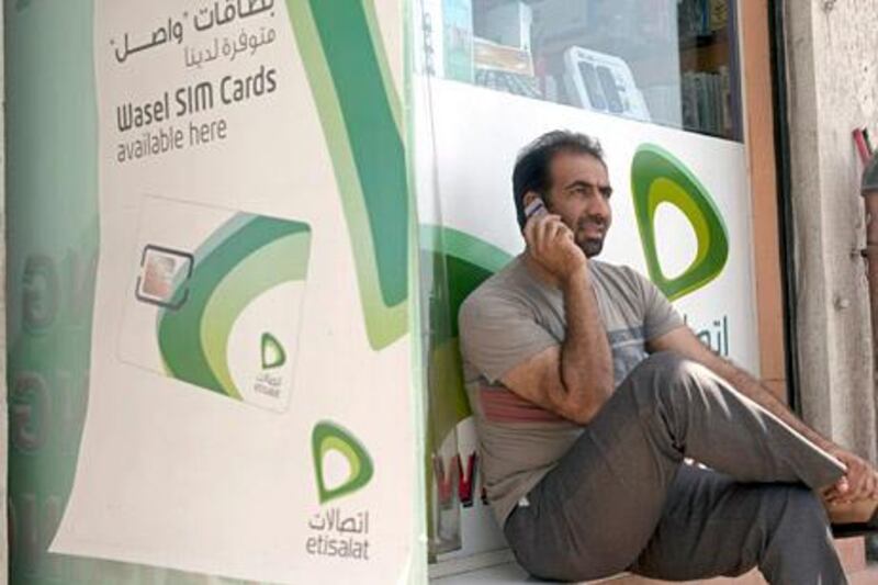 Dubai - May 21, 2011 - Ali Bidshahri calls a friend from the West Peacock mobile phone store in Al Satwa, Dubai, May 21, 2011. (Photo by Jeff Topping/The National) 
 