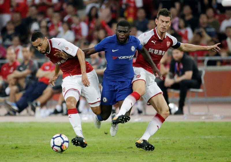 Chelsea's Jeremie Boga is tackled by Arsenal's Francis Coquelin and Laurent Koscielny. Jason Lee / Reuters