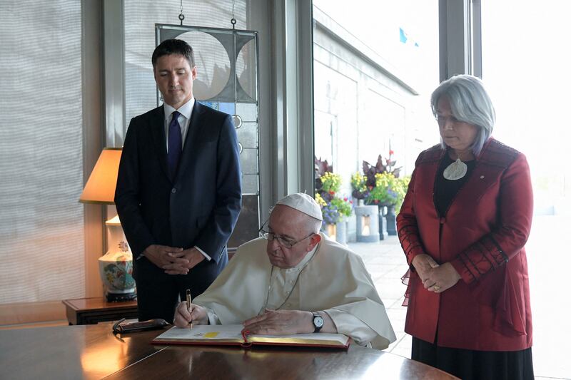 Mr Trudeau stands next to Pope Francis and Ms Simon  after a meeting with civil authorities, representatives of indigenous peoples and members of the diplomatic corps at the Citadelle. Vatican Media Handout / Reuters 