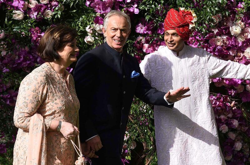 Former British Prime Minister Tony Blair (C) and his wife Cherie Blair (L) are welcomed by Indian businessman Anil Ambani (R), brother of Mukesh Ambani. Photo: AFP