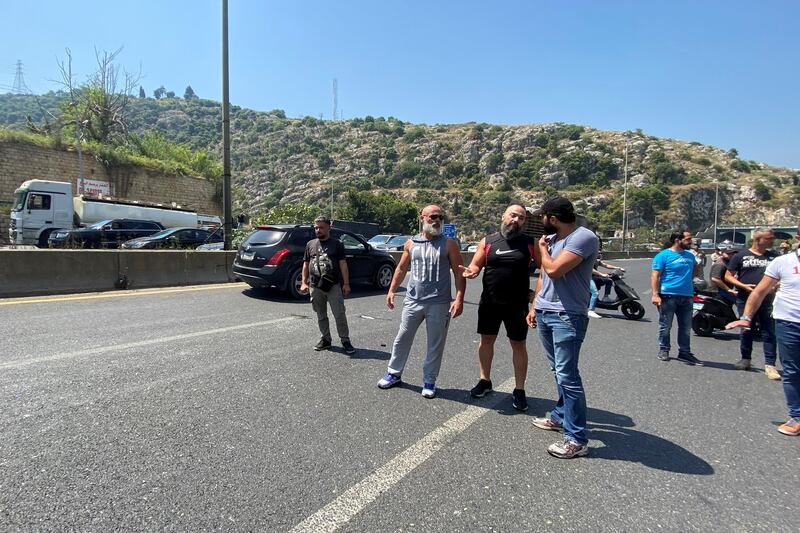 Protesters stand together to block the route of voters on a highway in Nahr El Kalb, Lebanon. Reuters