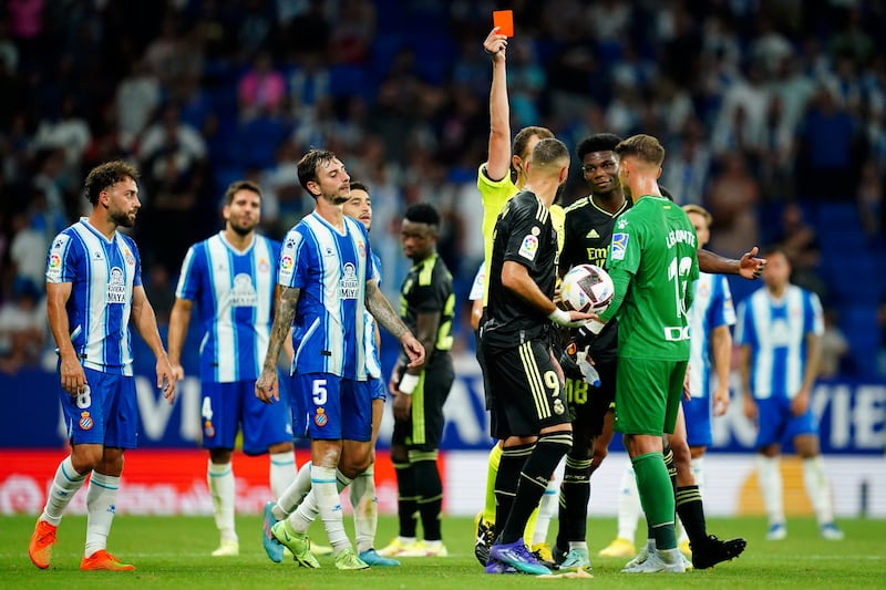Referee Melero Lopez shows a red card to Espanyol goalkeeper Benjamin Lecomte. AP