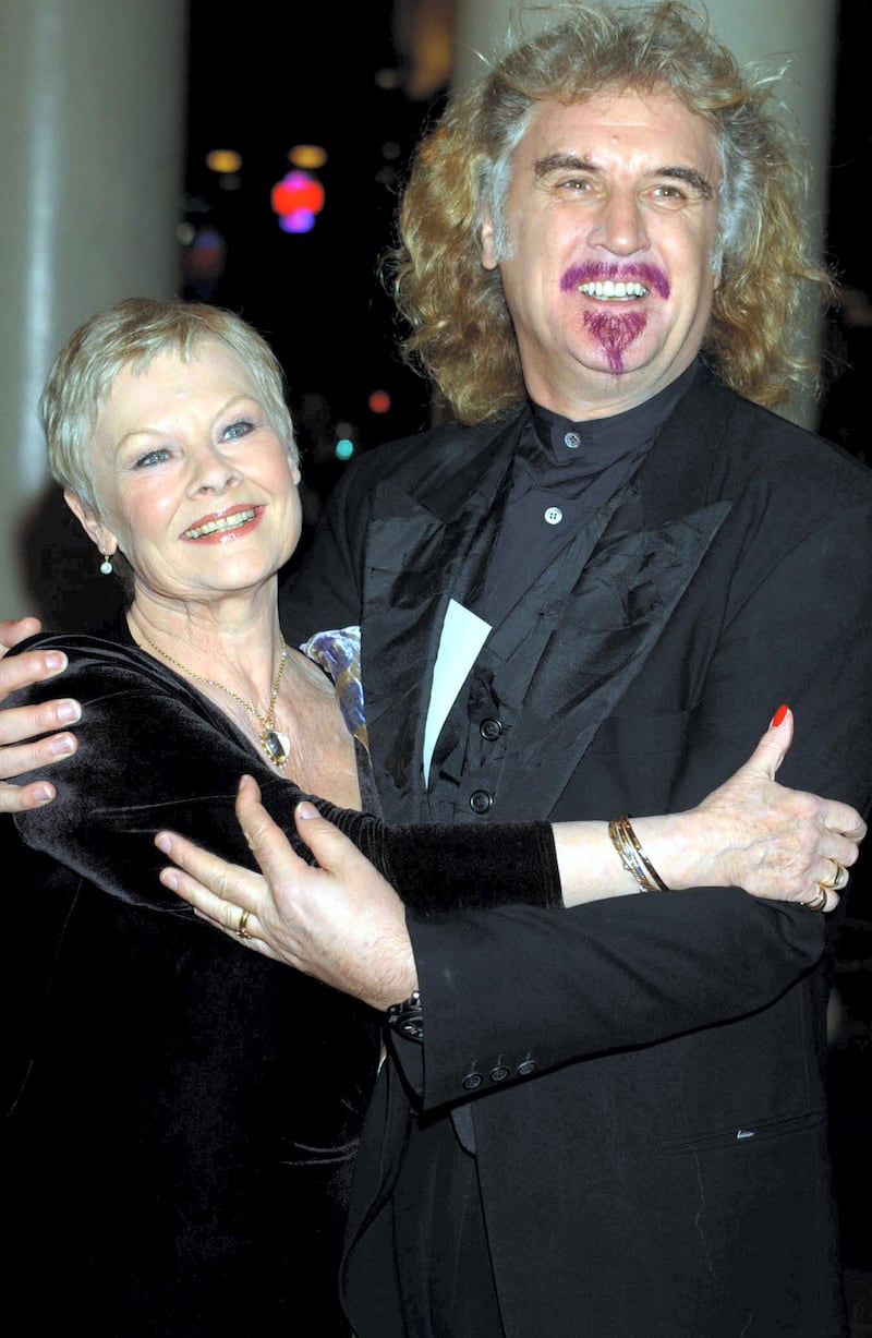 Dame Judi Dench and Billy Connolly arrive at the Theatre Royal, Haymarket, London, where she will receive her Academy Fellowship on her 67th birthday.   *  The presentation will take place at the theatre where she is currently starring in The Royal Family directed by Sir Peter Hall. The prestigious fellowship is the highest acolade awarded by the British Academy of Film & Television (BAFTA) and is in recognition of her work in both film and televison.  lwpgals   (Photo by William Conran - PA Images/PA Images via Getty Images)