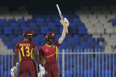 West Indies' Alick Athanaze (R) celebrates after scoring a half-century (50 runs) during the third one-day international (ODI) cricket match between the United Arab Emirates and West Indies at the Sharjah Cricket Stadium in Sharjah on June 9, 2023.  (Photo by KARIM SAHIB  /  AFP)
