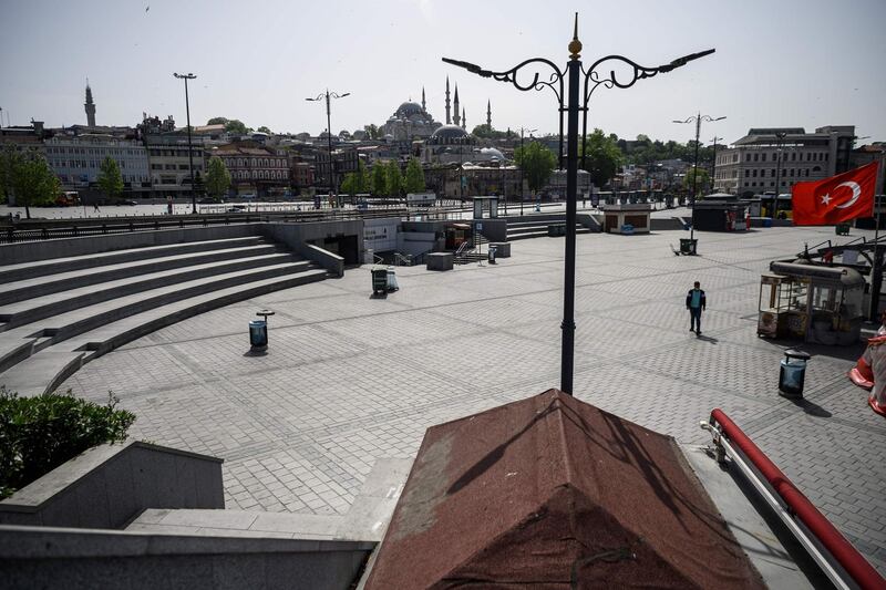 A man walks in the deserted Eminonu square in Istanbul, during a four-day curfew.  AFP