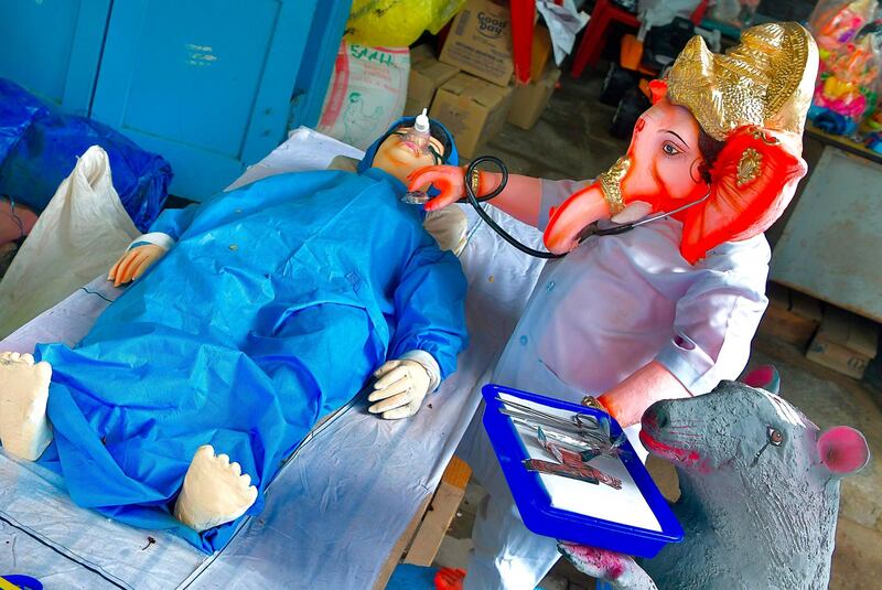 Plaster idols depict the present pandemic scenario where Hindu God Ganesh is treating a patient for coronavirus, ahead of the Ganesh Chaturthi Festival, in Bangalore. AFP