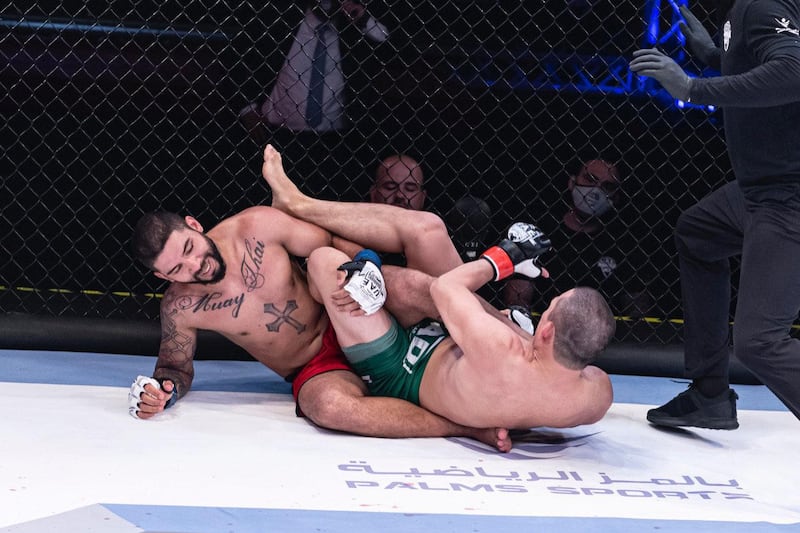 Jung Han-gook (green shorts) is about to apply a foot-lock on Max Lima. credit to UAE Warriors 

