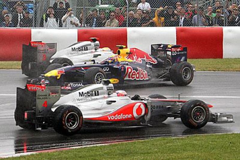 Red Bull's Webber, centre, and Hamilton collide in the Senna corner as Button drives.