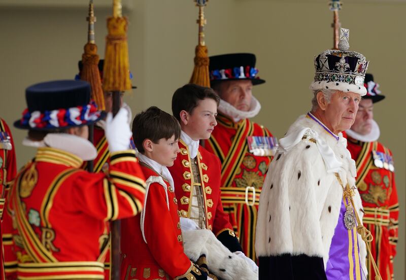 King Charles arrives to receive a royal salute from members of the military in the gardens of Buckingham Palace following his coronation 