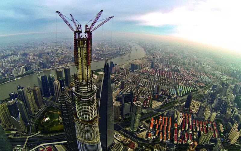 Shanghai’s modern heart is demonstrated by the under-construction Shanghai Tower, centre, and the Shanghai World Financial Centre, right. China Out / AFP