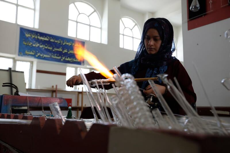 A technician fashions laboratory glass tubes at a center of teaching aids production in Sanaa, Yemen.  EPA