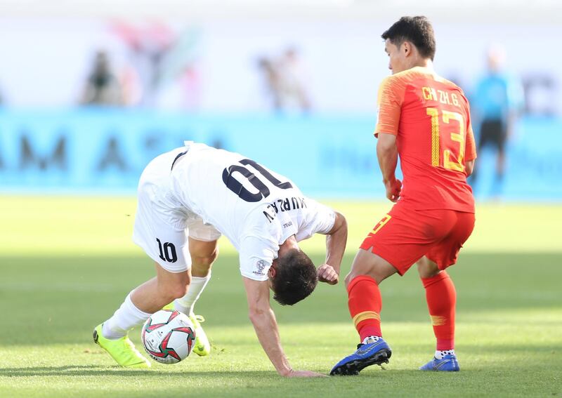 China's Chi Zhongguo, right, watches on as Sagynbaev Bekzhan falls over. EPA