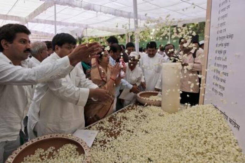 India's Congress party workers pay floral tribute to those killed in Saturday's Maoist attack in Chhattisgarh at a prayer meeting held at the party's headquarters in New Delhi, India, Monday, May 27, 2013. Troops fanned out across central India on Monday in a massive manhunt days after hundreds of Maoist rebels attacked a convoy of ruling party members and leaders, killing 24 people in an area considered the stronghold of the rebels, police said. (AP Photo/Manish Swarup) *** Local Caption ***  India Rebel Attack.JPEG-08b17.jpg