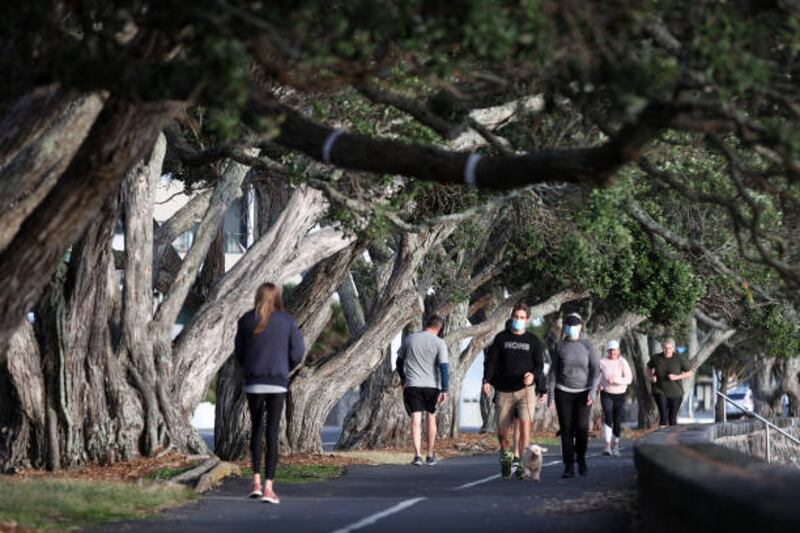 People exercise along Tamaki Drive on Auckland's waterfront, on August 24. Daily walks are permitted under the level 4 lockdown. Getty