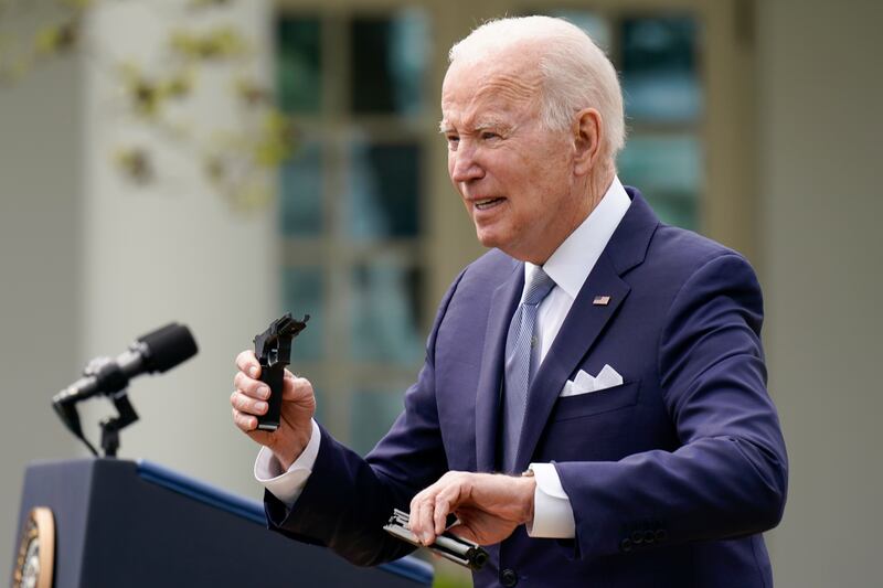 President Joe Biden displays pieces of a 9mm pistol at an event announcing new rules to regulate 'ghost guns', unserialised home-made weapons that are difficult for police to track. AP