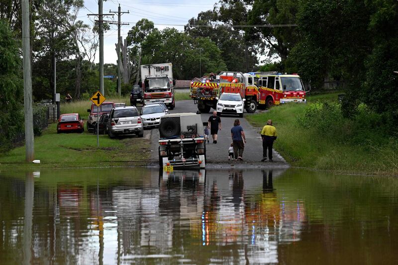 Fire and rescue officials arrive in a flooded area of Windsor after Hawkesbury River burst its banks. AFP