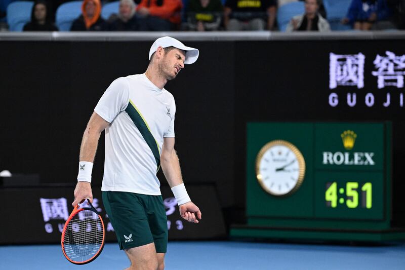 Andy Murray walks past the clock during the fifth set. AFP