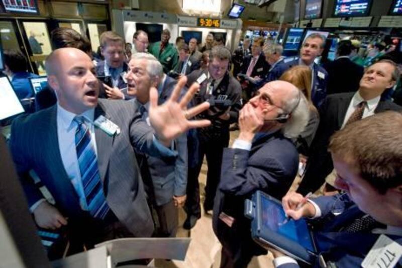 Specialist Henry Becker, left, directs trading at the post that handles AIG on the floor of the New York Stock Exchange, Tuesday Sept. 16, 2008. Stocks extended their decline and bond prices jumped Tuesday, a day after Wall Street's worst session in years, as nervous investors grappled with concerns about insurer American International Group Inc. and awaited the Federal Reserve's decision on interest rates. (AP Photo/Richard Drew) *** Local Caption ***  NYRD101_APTOPIX_Wall_Street.jpg