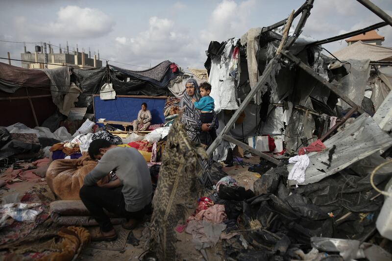 Palestinians sit among the remains of their tents after Israeli bombardment close to an UNRWA centre in the west of Rafah city on May 28. AP